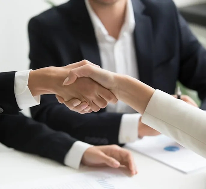 People shaking hands over a business meeting