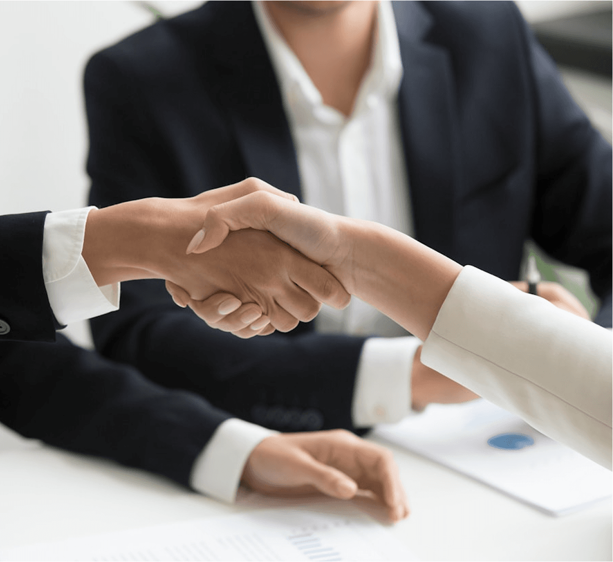 People shaking hands over a business meeting