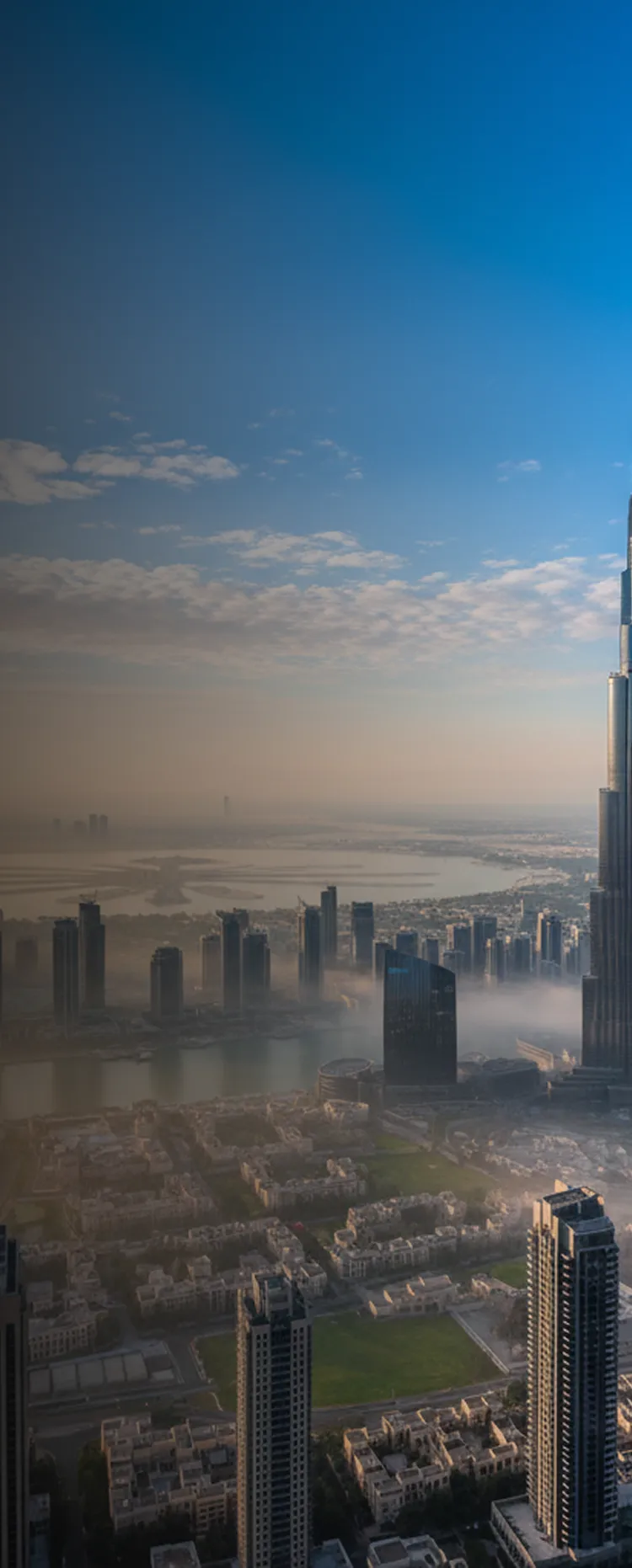 Aerial view of the Dubai skyline with the Burj Khalifa above morning fog