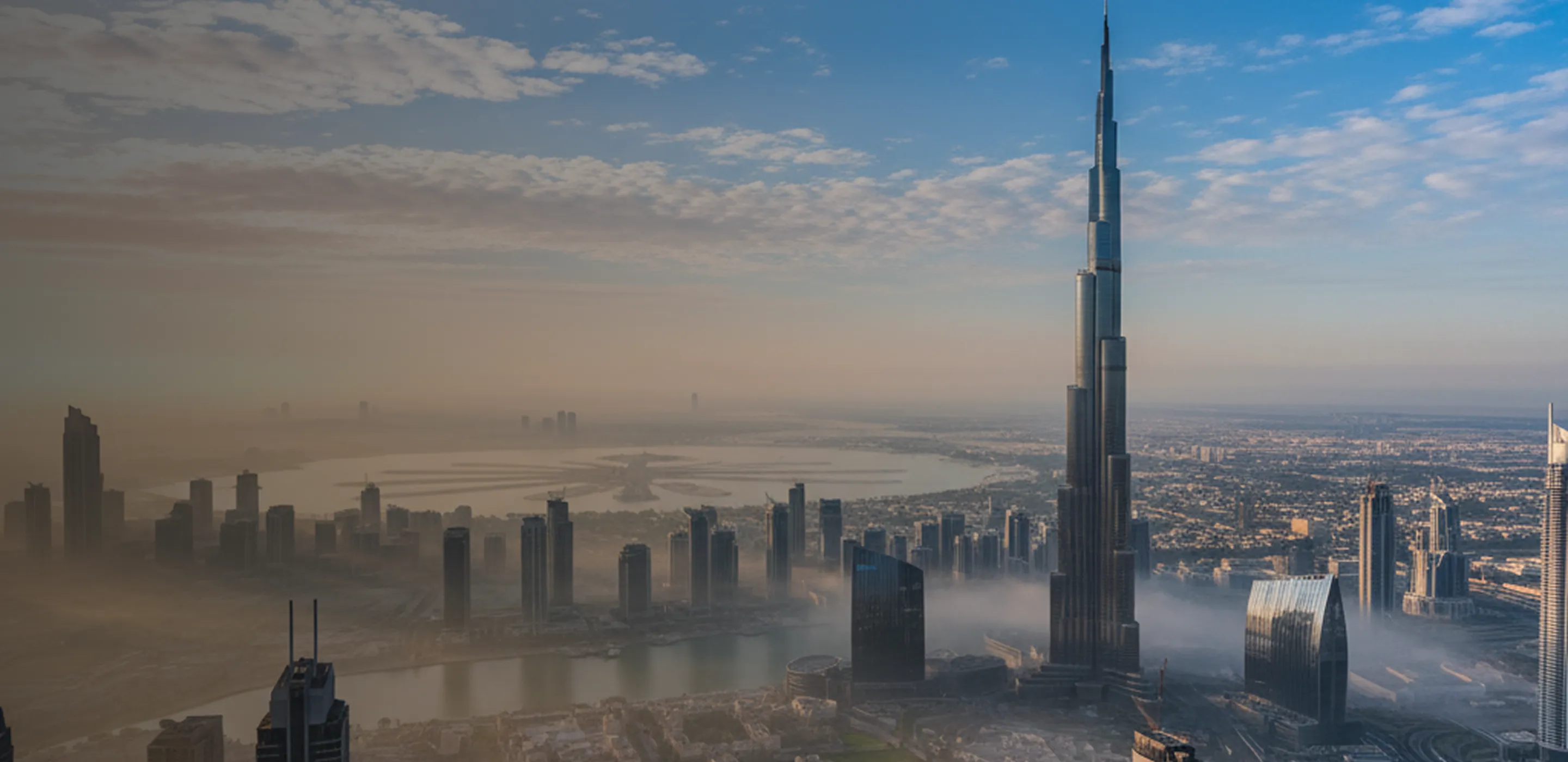 Aerial view of the Dubai skyline with the Burj Khalifa above morning fog